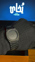 Black watch on a gloved hand with a brandind "Ukhaai"on it.(frontside)