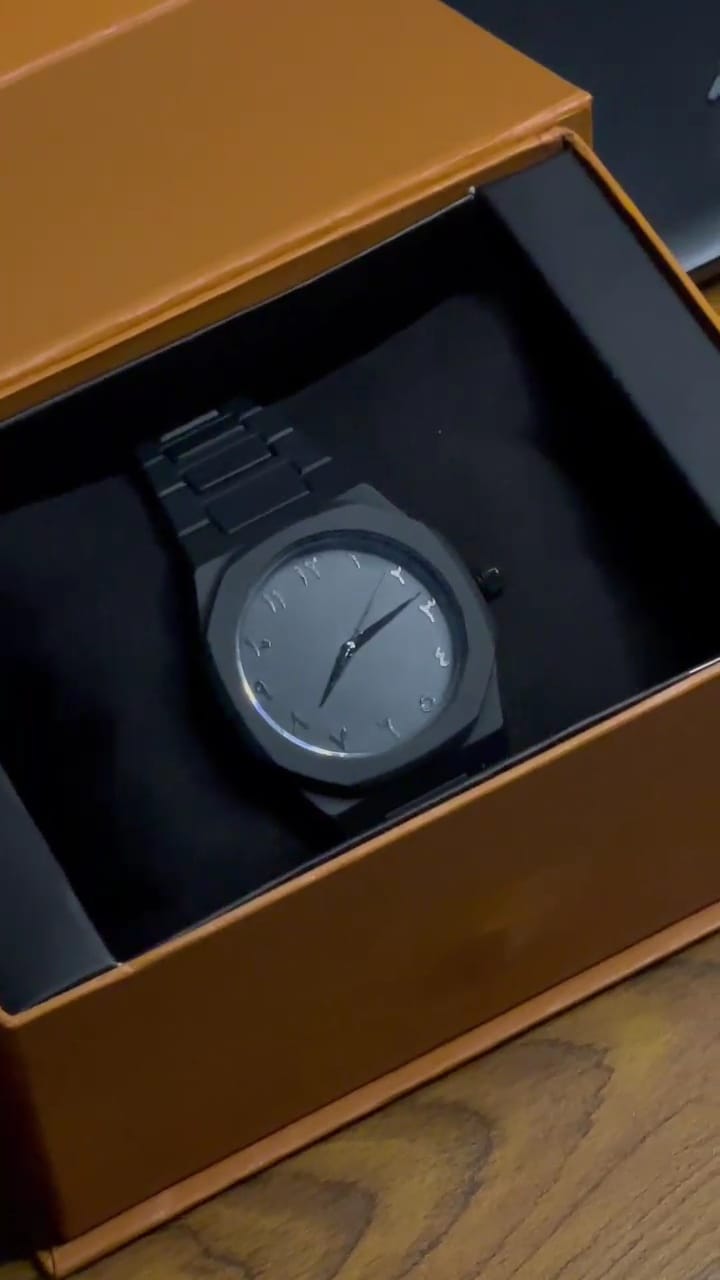 Watch in a brown box on a wooden surface 